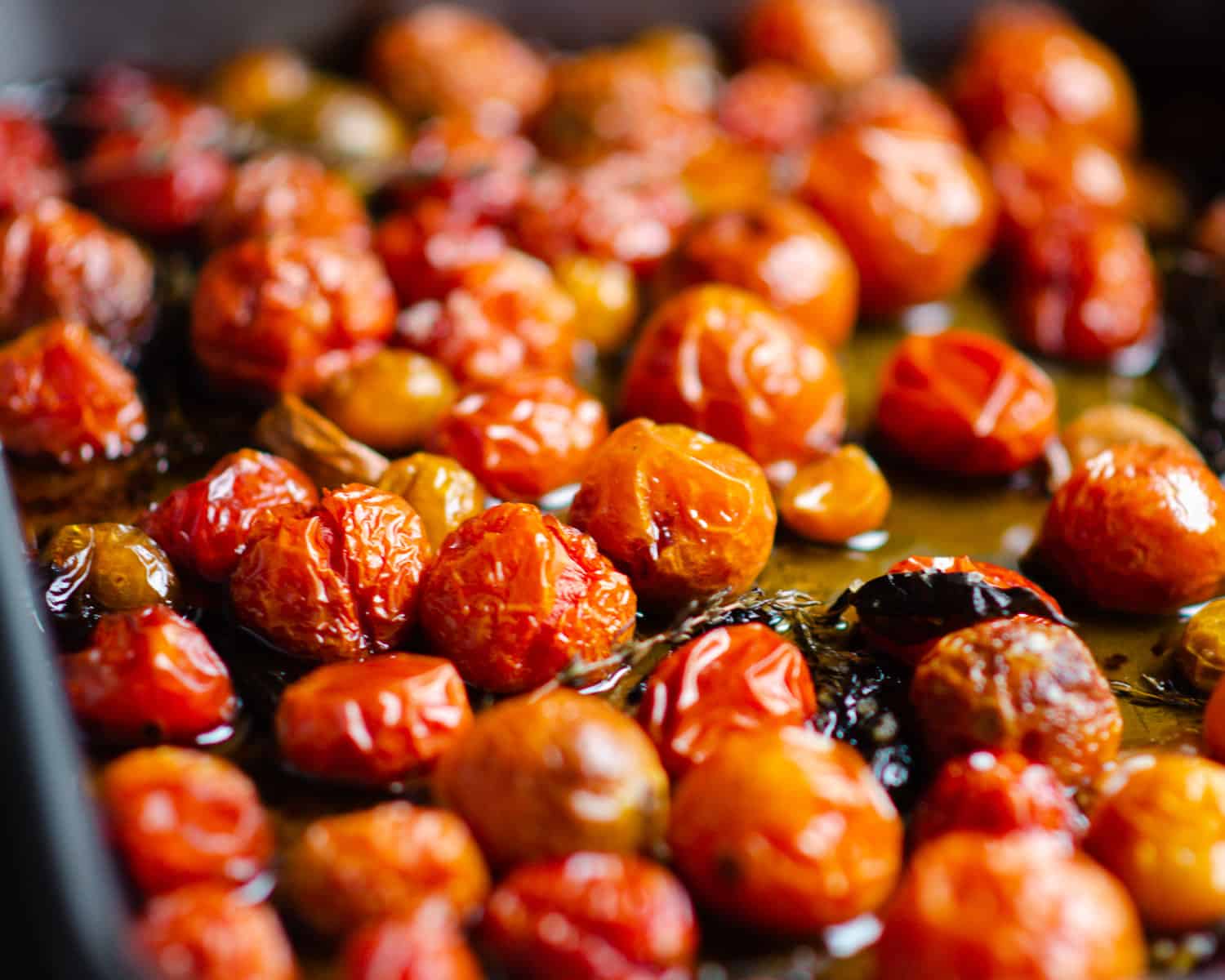 Wilted cherry tomatoes and juices in a pan. 