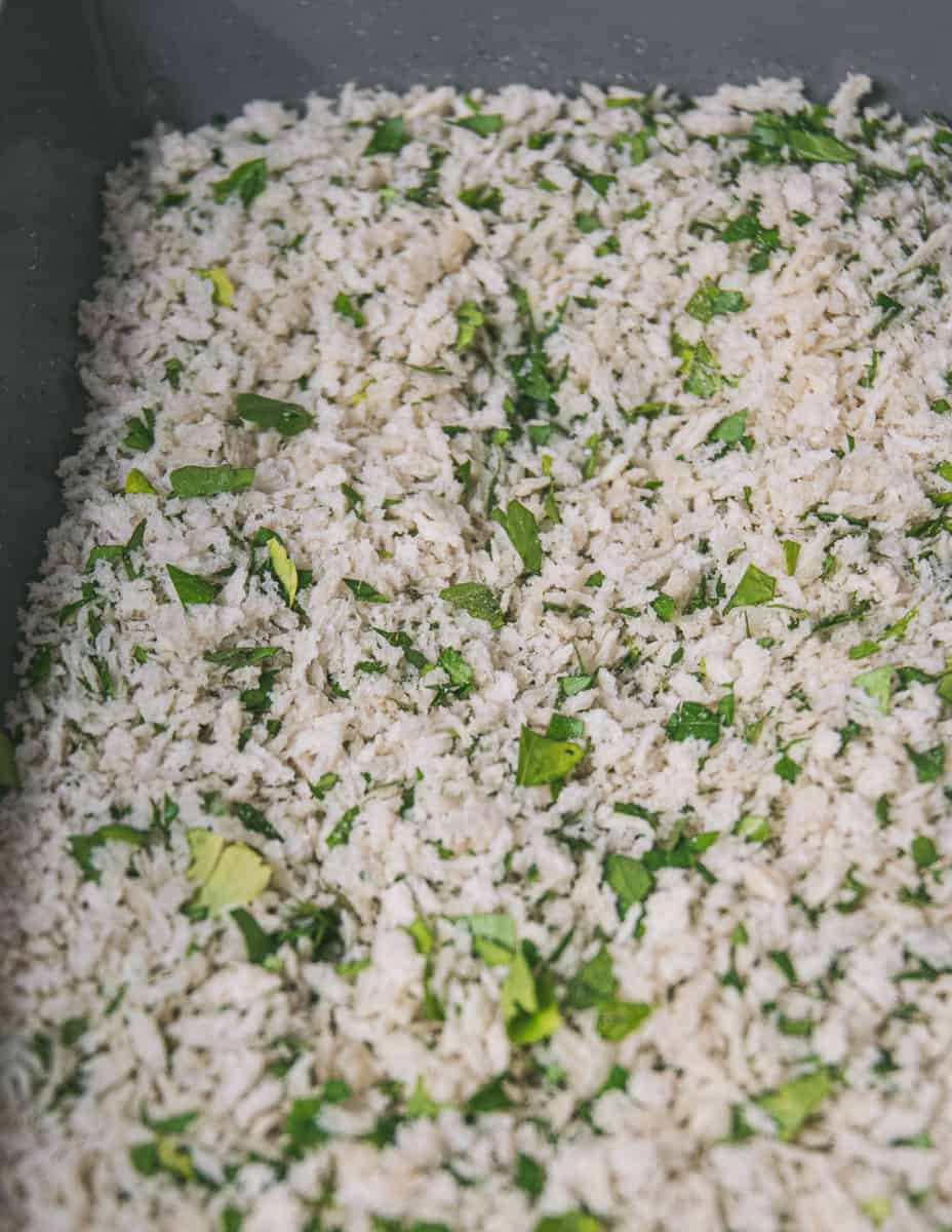 Close up of panko bread crumbs that have been mixed together with finaely chopped parsley. 