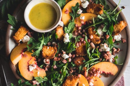salad of arugula, peaches, goat cheese crumbles and croutons,