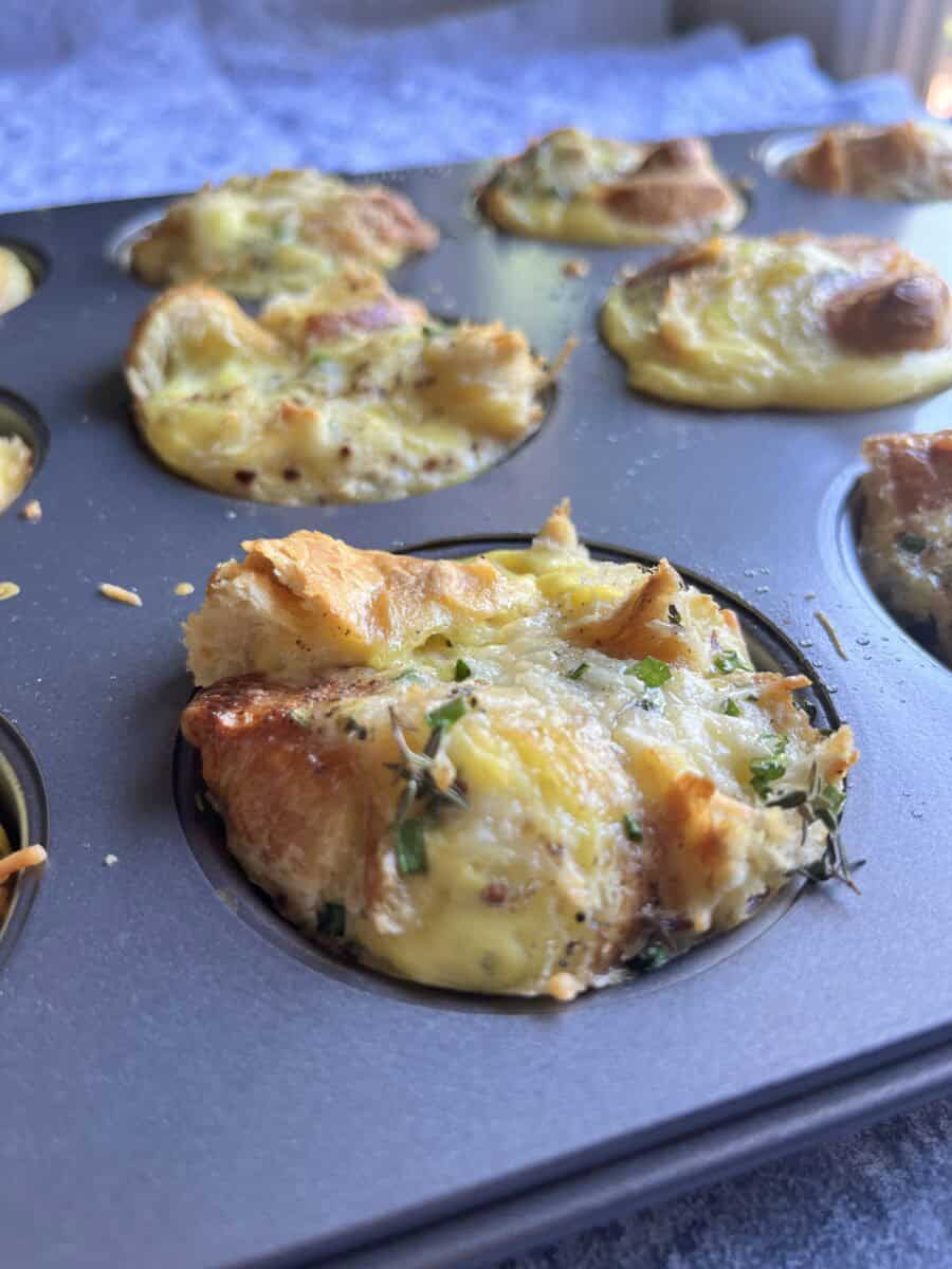 Savory croissant egg bites cooling in muffin tray